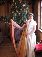 Harpist Anne Roos next to Christmas Tree