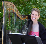 Anne Roos smiling with her harp